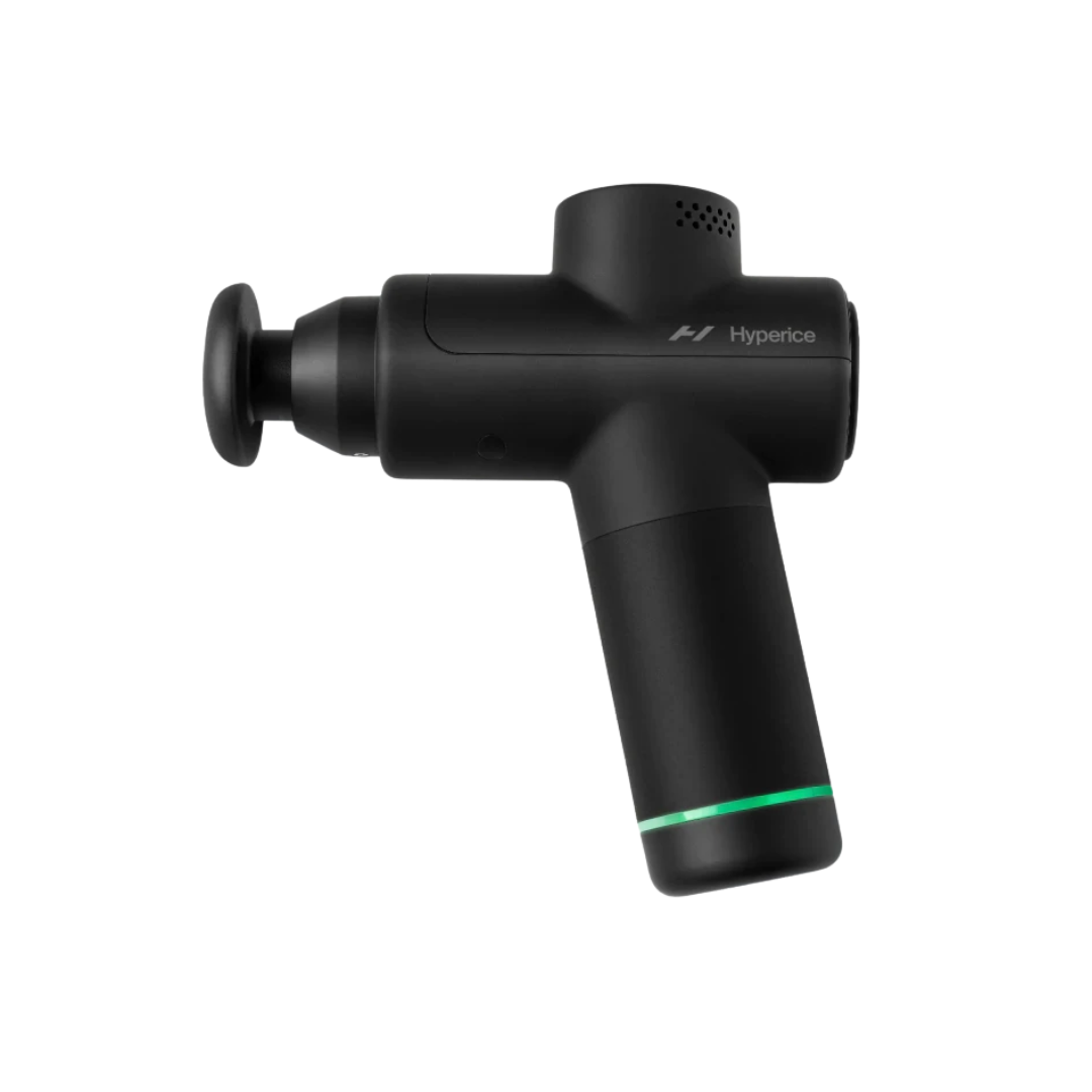 A compact, matte black handheld percussion massage gun with a signature green LED ring at the base of the handle.