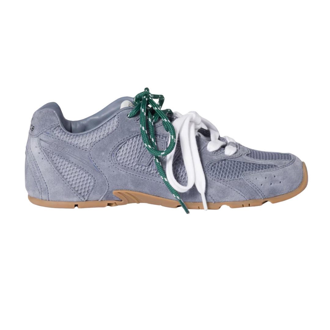 A light blue frayed suede New Balance x Miu Miu sneaker with thick white and green laces.