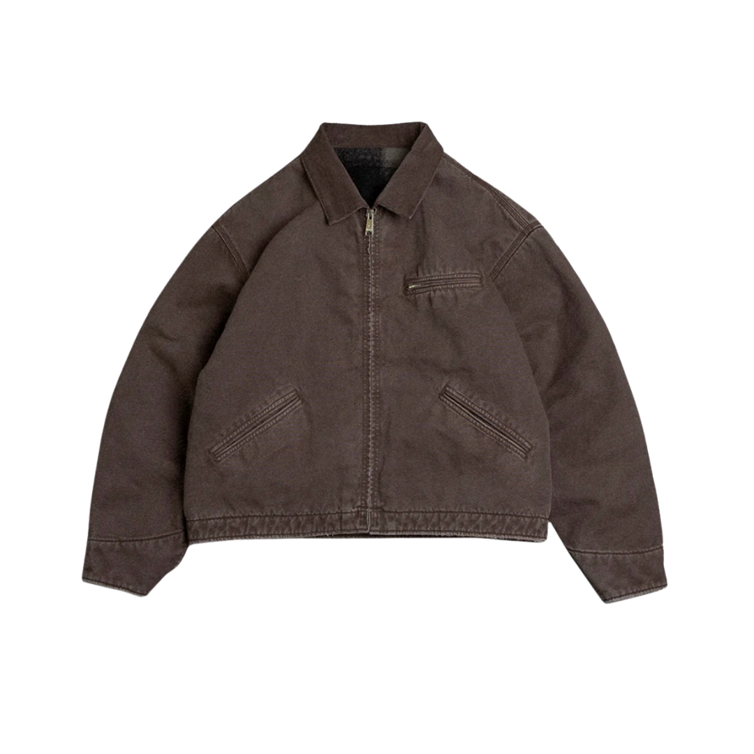 A dark brown, heavy-duty canvas work jacket with a structured collar and a front zip pocket.