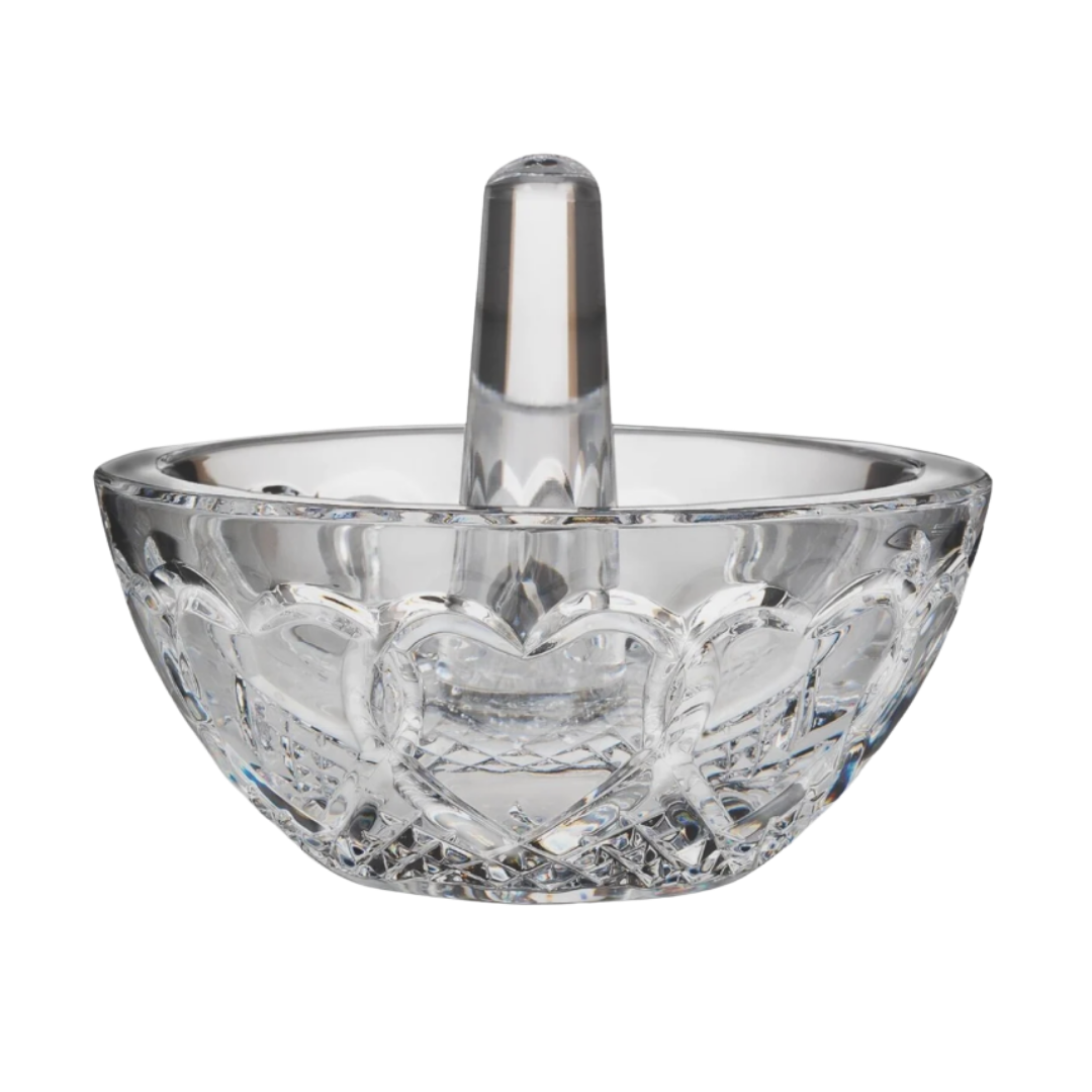 A brilliant-cut crystal ring dish featuring an intricate heart-patterned base and a solid crystal center post.