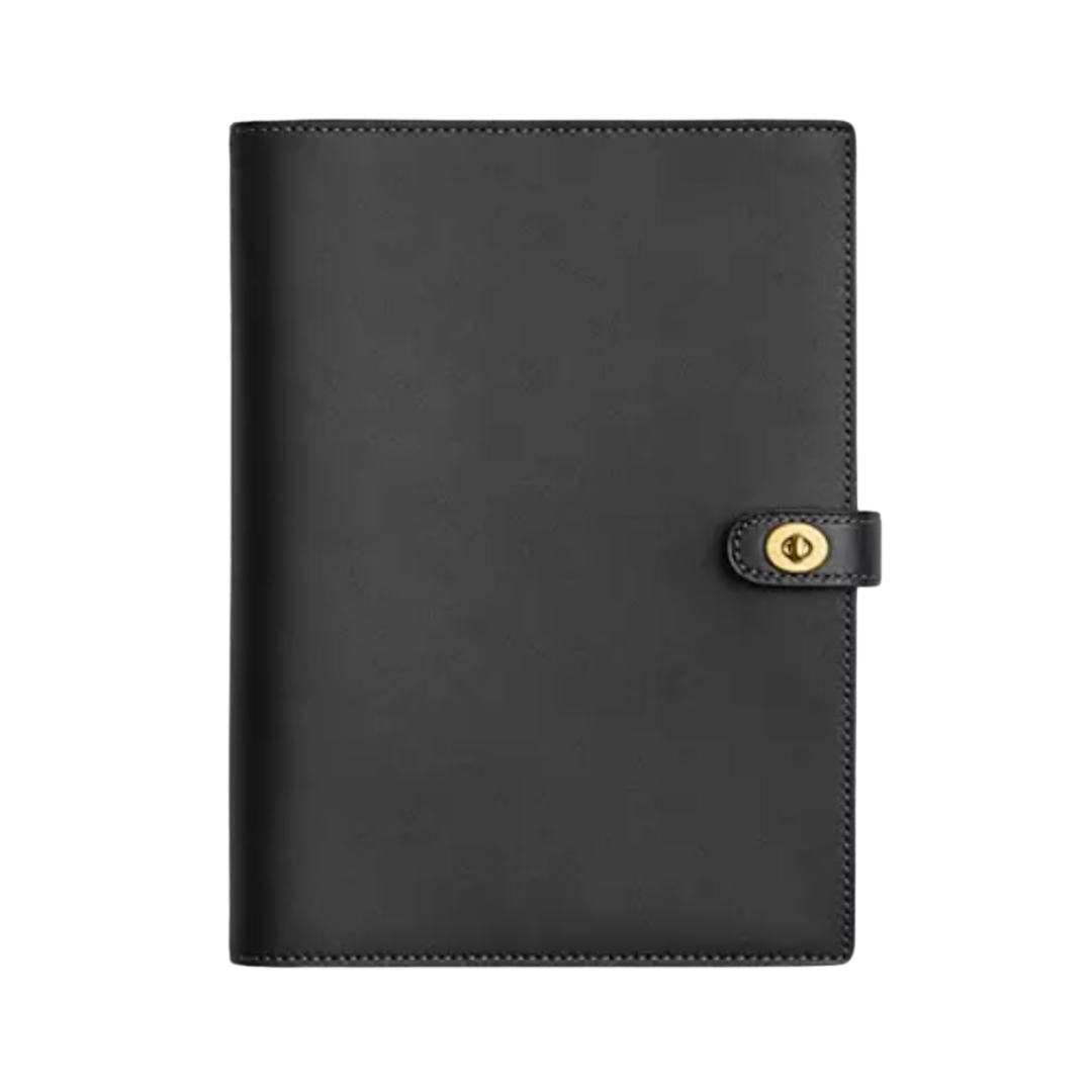 A vertical black pebbled leather notebook cover with a small gold clasp closure.