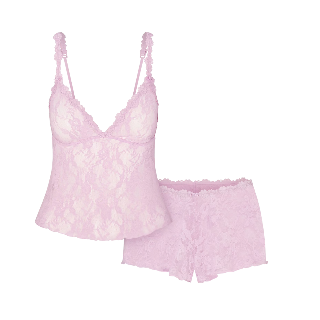 A two-piece light pink sheer lace loungewear set including a triangle camisole top and matching high-waisted shorts.