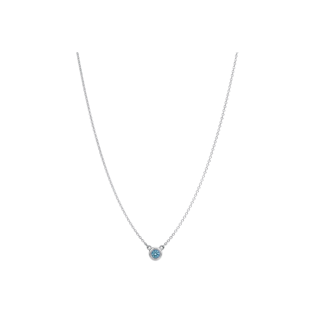 A delicate silver chain necklace with a single round, brilliant-cut light blue aquamarine gemstone pendant.
