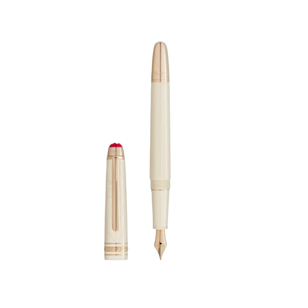 A luxury ivory-colored fountain pen with gold trim, shown with its cap standing next to it.