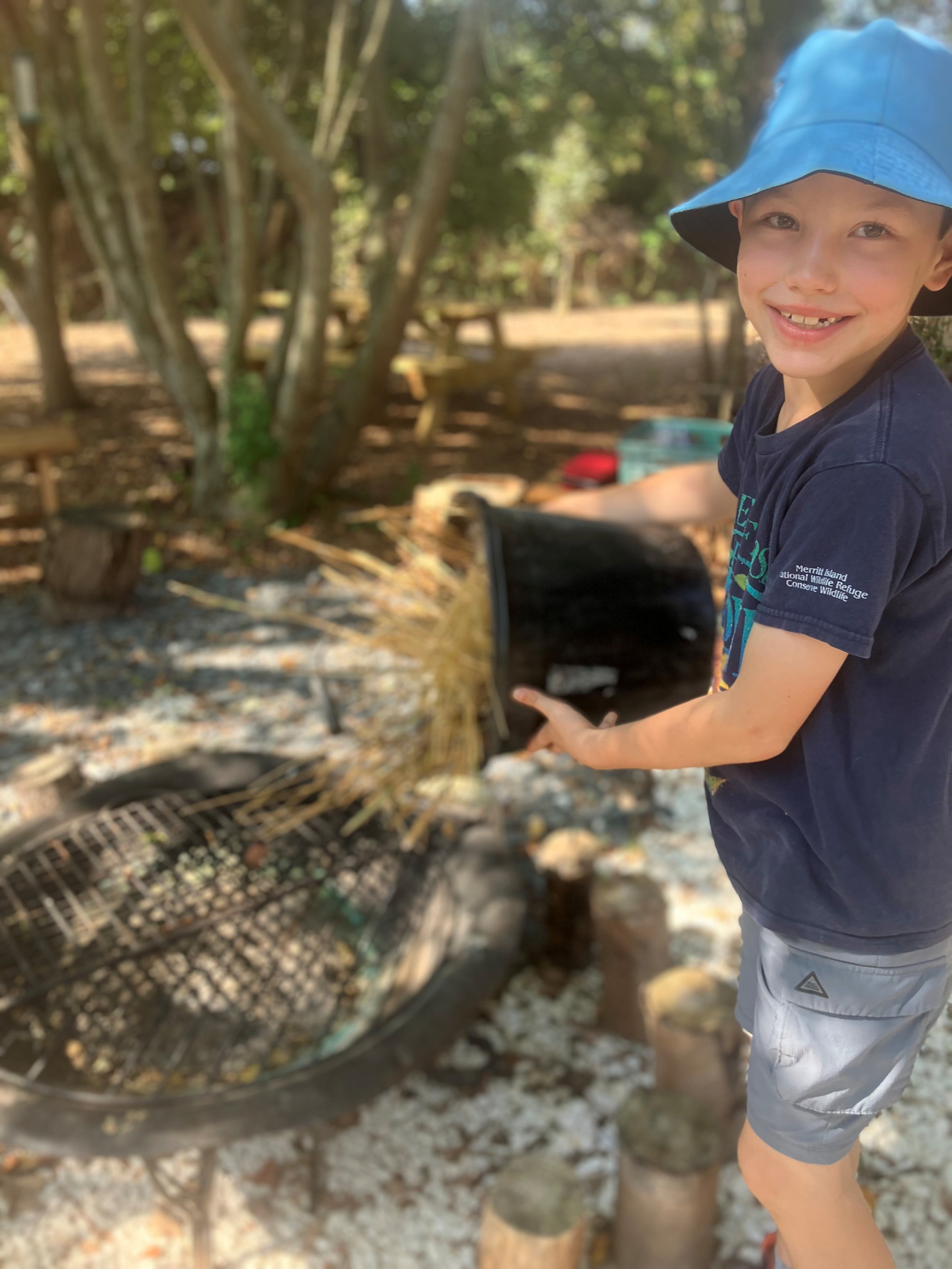 Two young people engaging in the GroWet area undertaking activities to help grow endangered wetland plants.