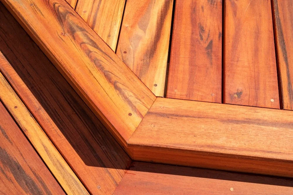 Close-up of a wooden deck with geometric design and visible wood grain texture.
