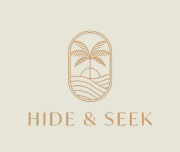 A logo featuring a line drawing of a palm tree, sun, and ocean waves, with the words 'HIDE & SEEK' underneath.