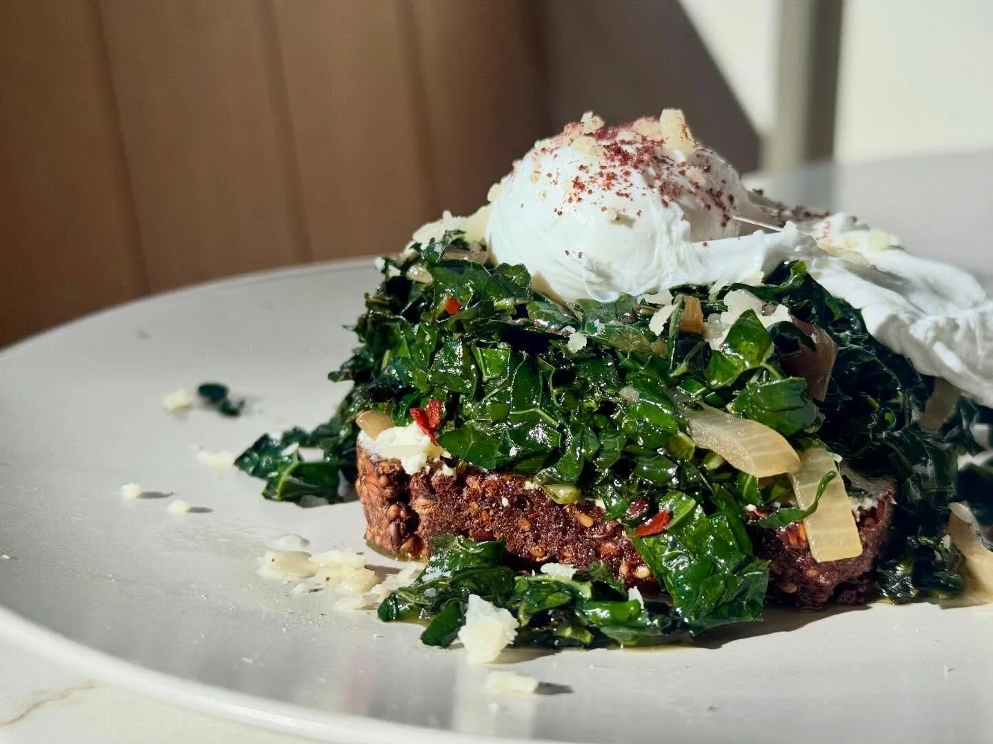 Our Poached Egg on Danish Rye is gaining popularity and for a good reason! Hearty and healthy, an organic poached egg sits atop a bed of spiced saut&eacute;ed kale and shallots, fromage blanc and a toasted slice of our Danish Rye (which you can also 