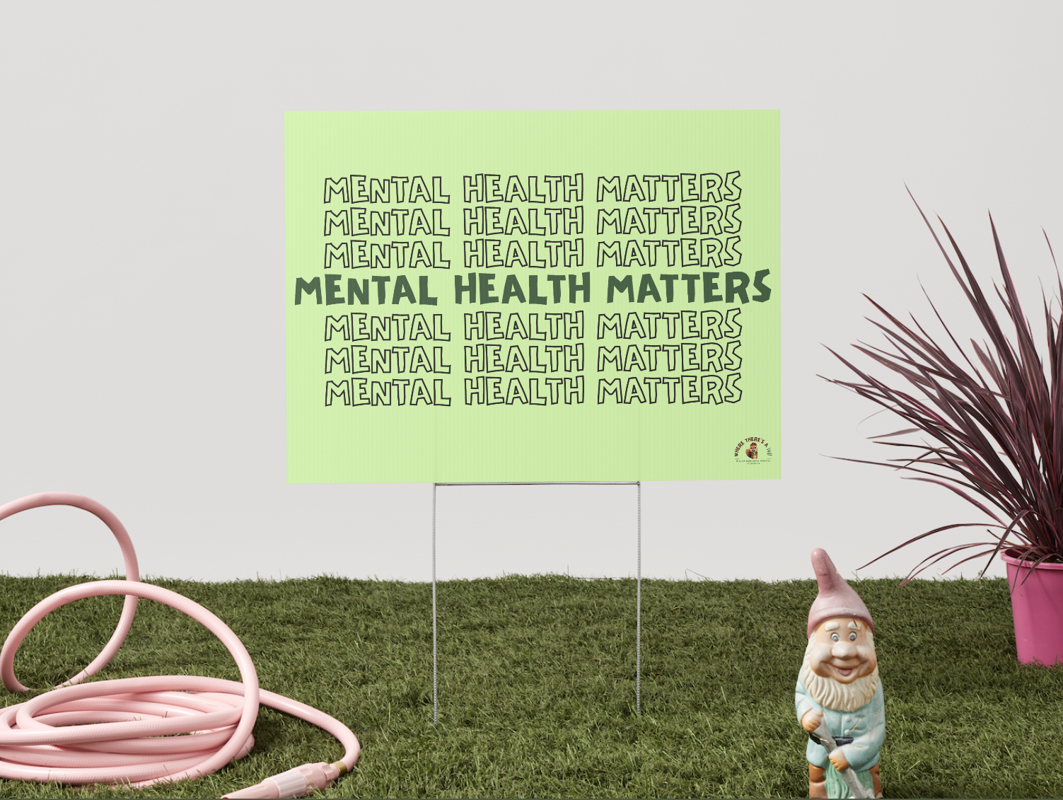 light green yard sign with repeating text saying mental health matters