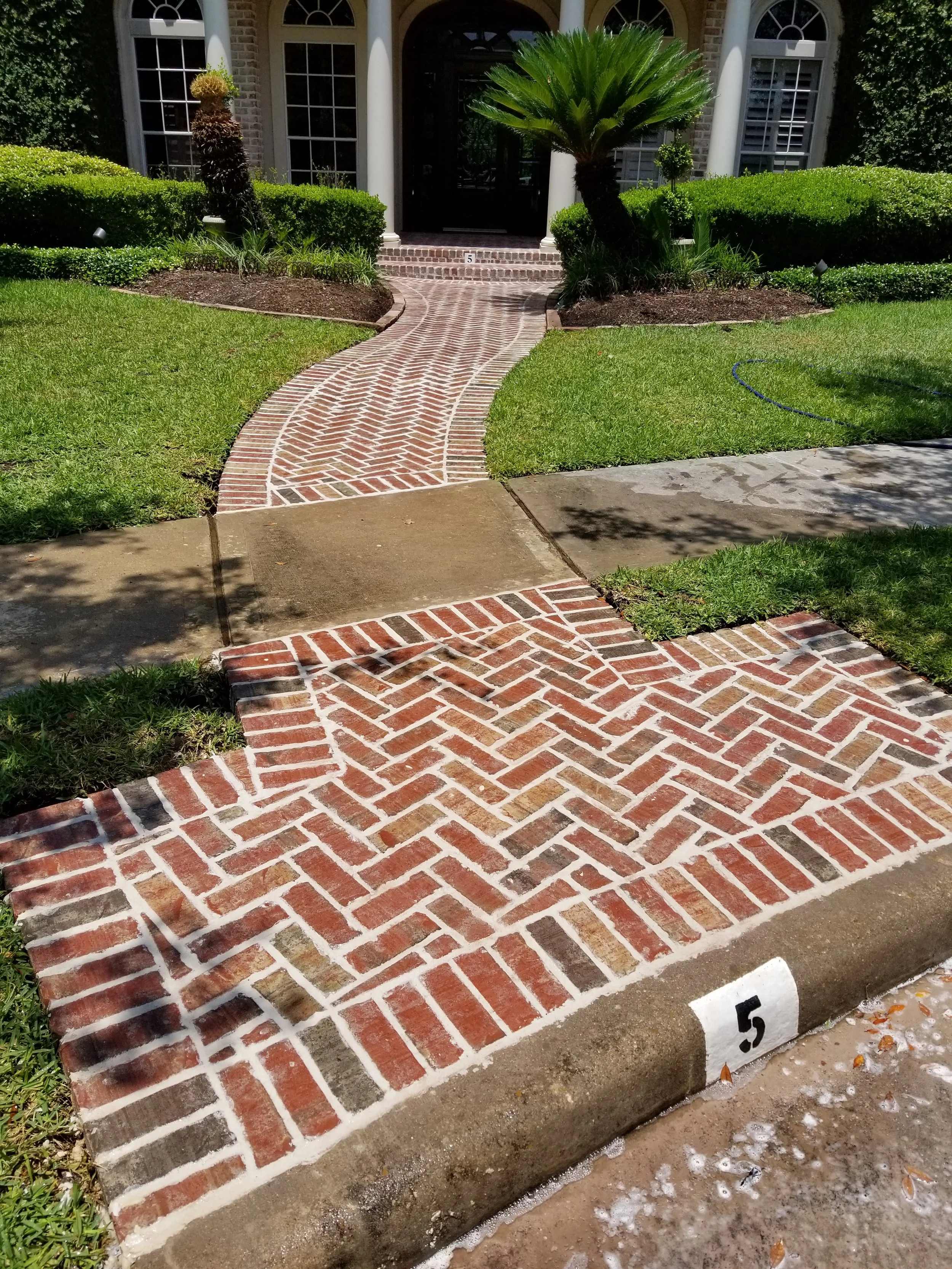 Front walkway made from brick in a herringbone pattern