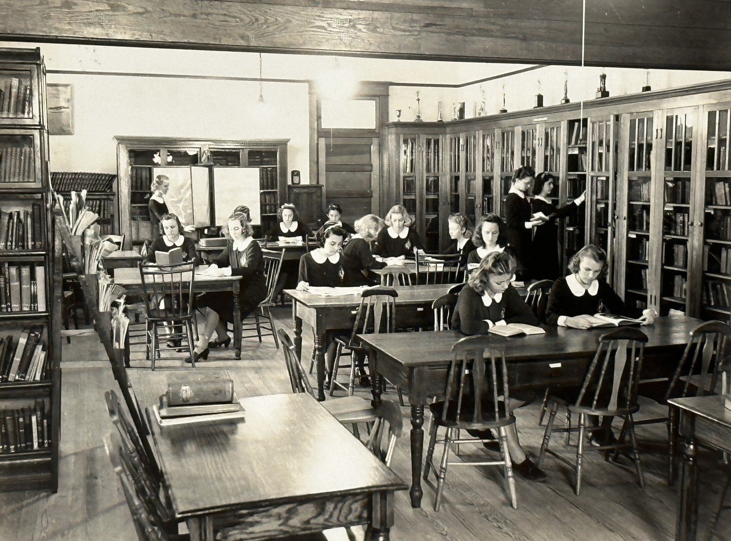 #FromTheArchivesFriday 
Summer is almost over, and it's time to hit the books! 📚 Check out this throwback to the 1940s, with Saint Joseph Academy students studying diligently in the library. Do you recognize any of these dedicated learners?