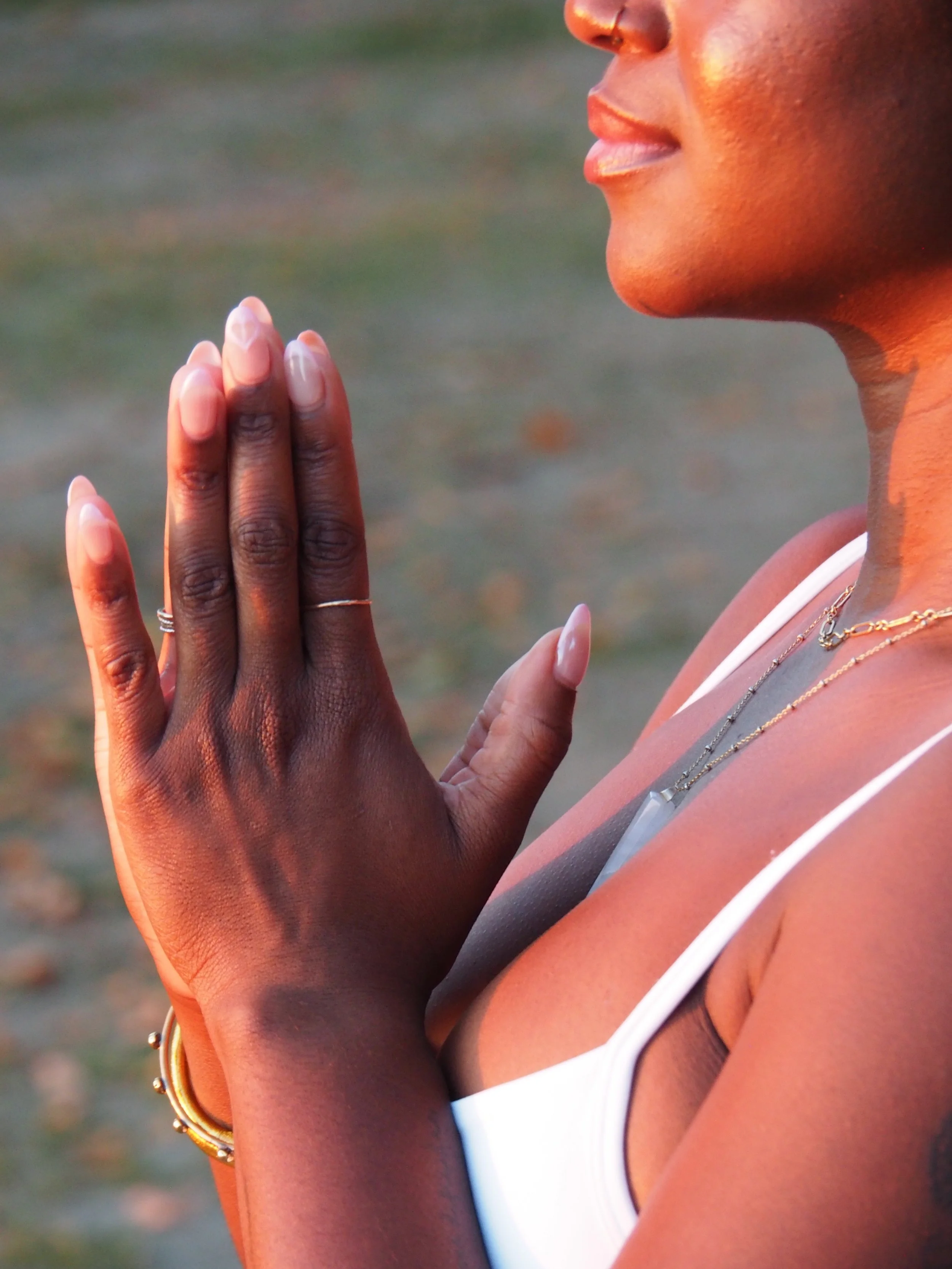 Yoga teacher with hands in prayer mudra