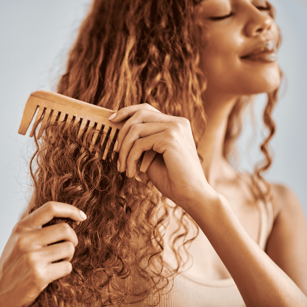 Woman using Neem Comb for Stronger fuller Hair