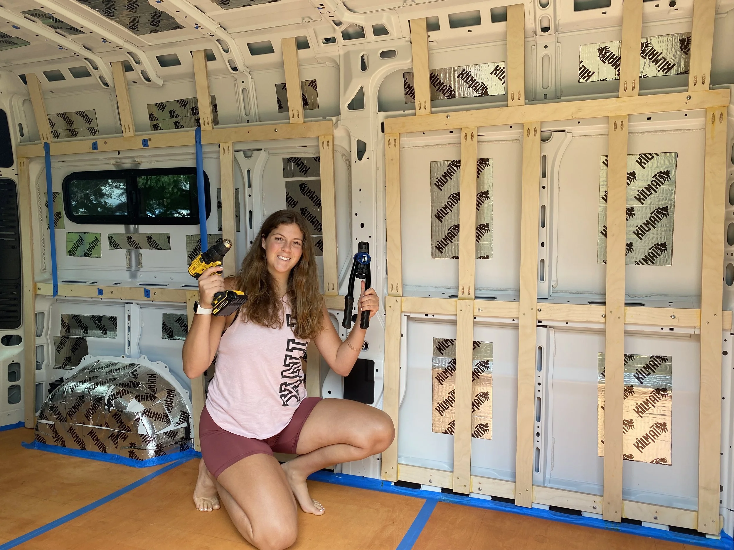 Lauren Lawliss installing furring strips during the early stages of her DIY sprinter van conversion