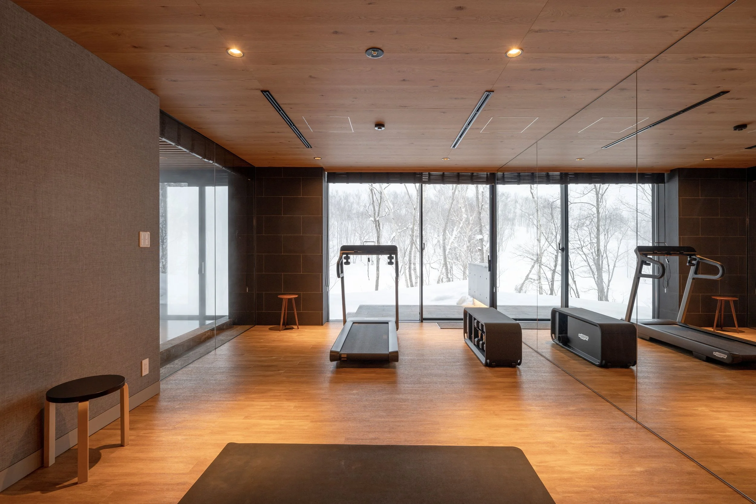 Tsubasa at Hanaridge Chalet fitness room with a treadmill, weights and yoga mats