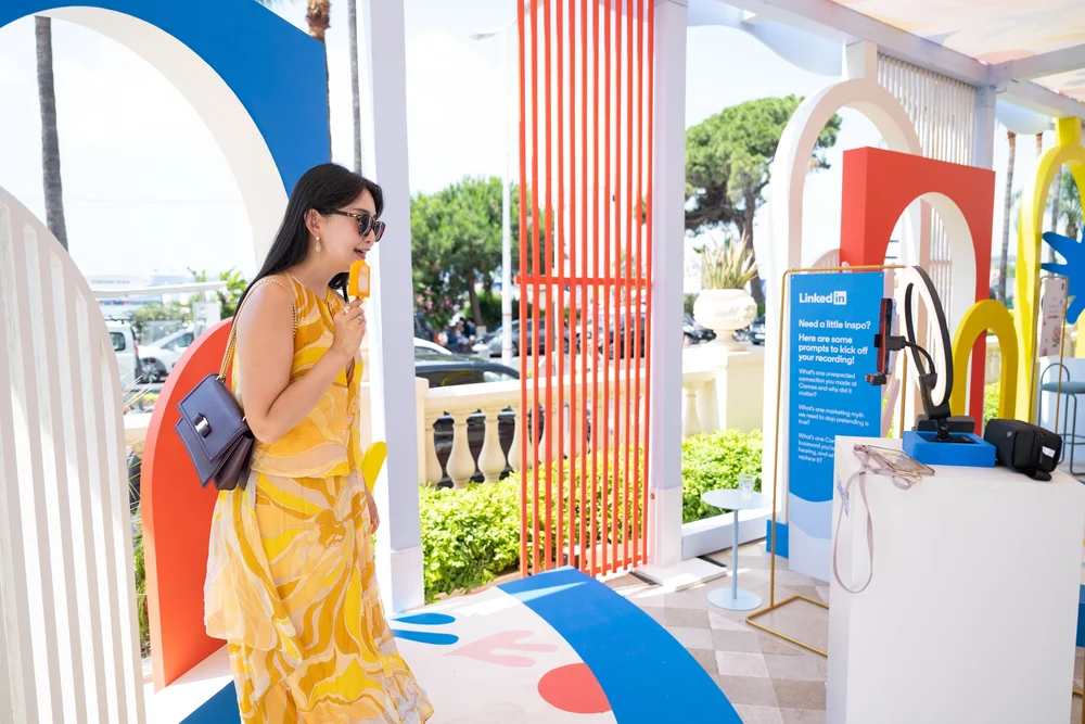 Guest enjoying an ice lolly in the colourful LinkedIn space at Cannes Lions