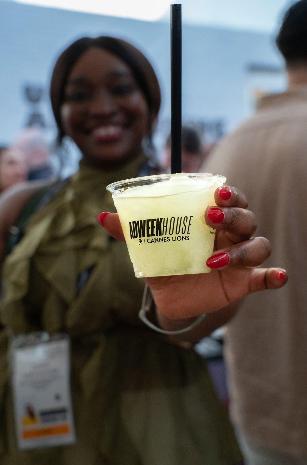 Guest holding a frozen drink in an Adweek House Cannes Lions cup