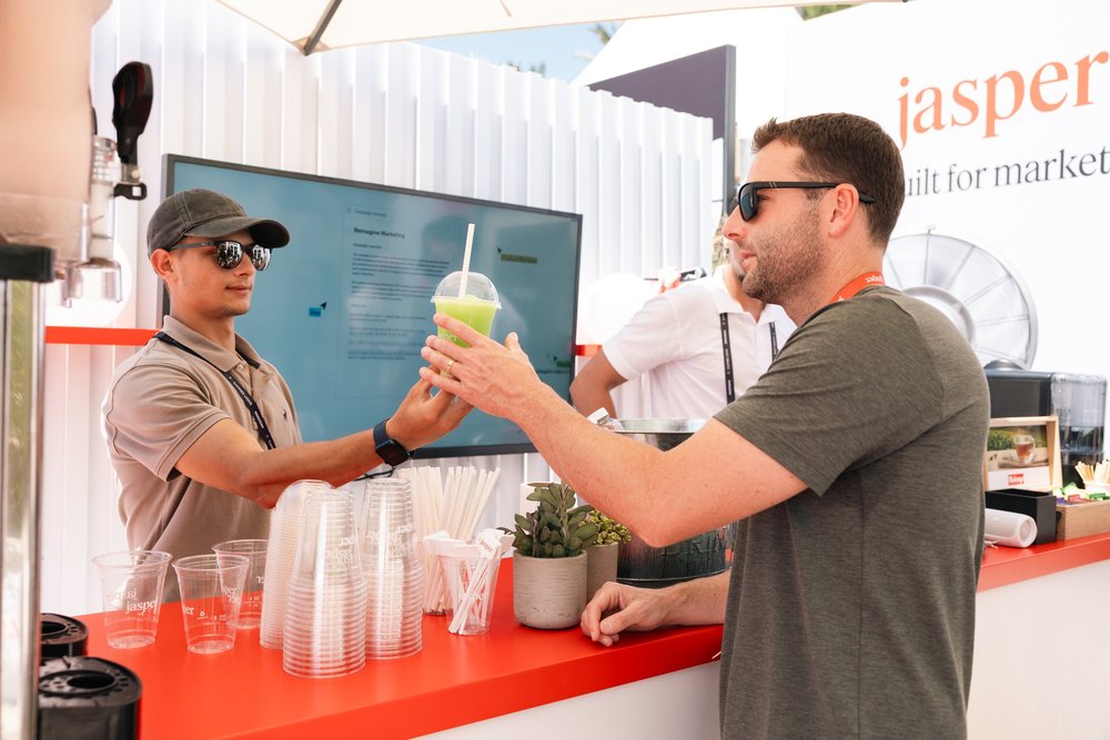 Team member handing a guest a slushie at the Jasper Cannes bar
