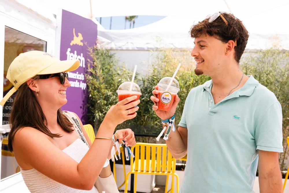 Guests holding Fetch branded smoothies at Cannes Lions