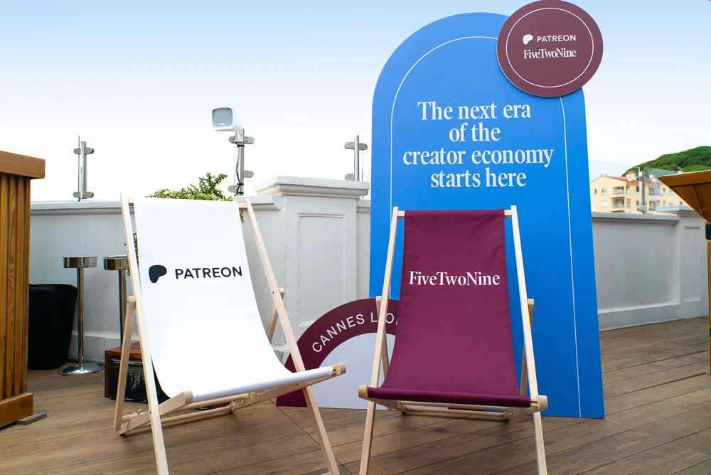 Patreon and FiveTwoNine deckchairs beside custom Cannes event signage