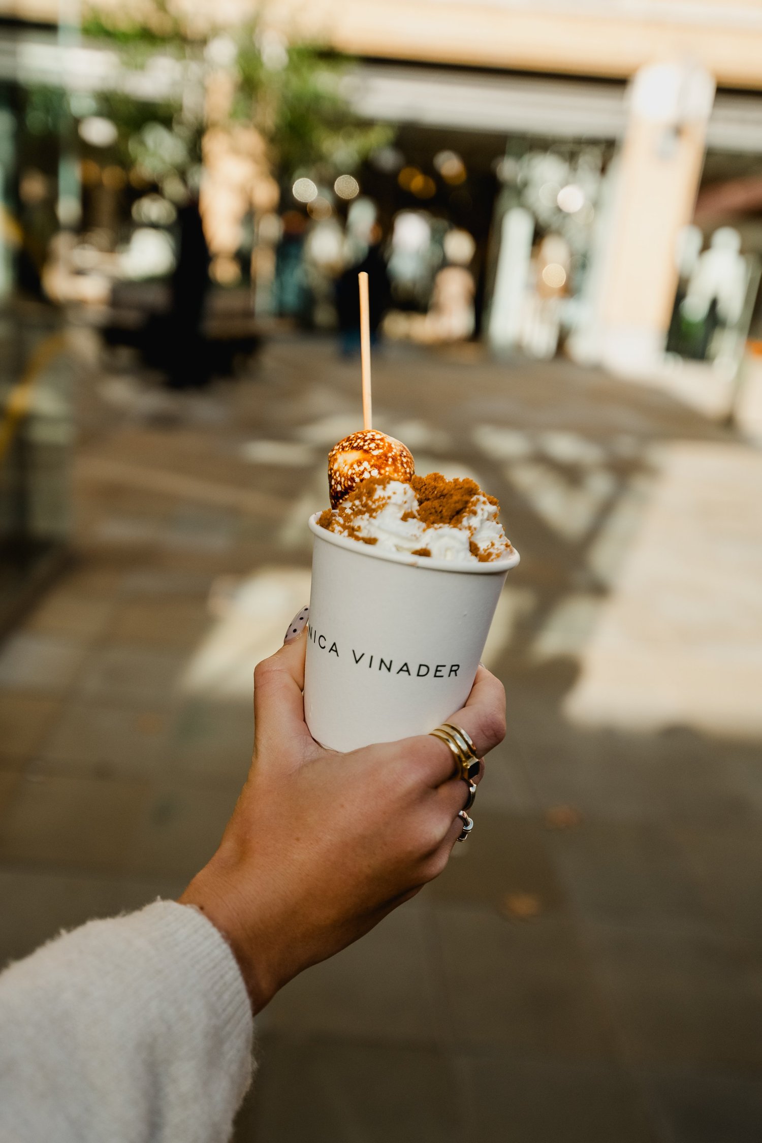 Monica Vinader branded cup of hot chocolate with whipped cream and toppings