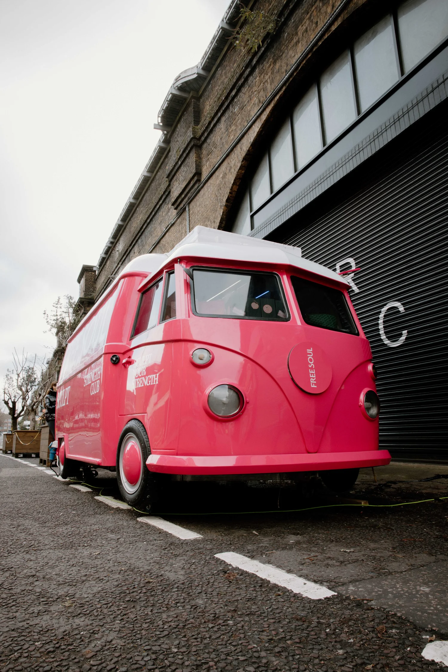 Bright pink Free Soul promotional truck viewed from the front corner