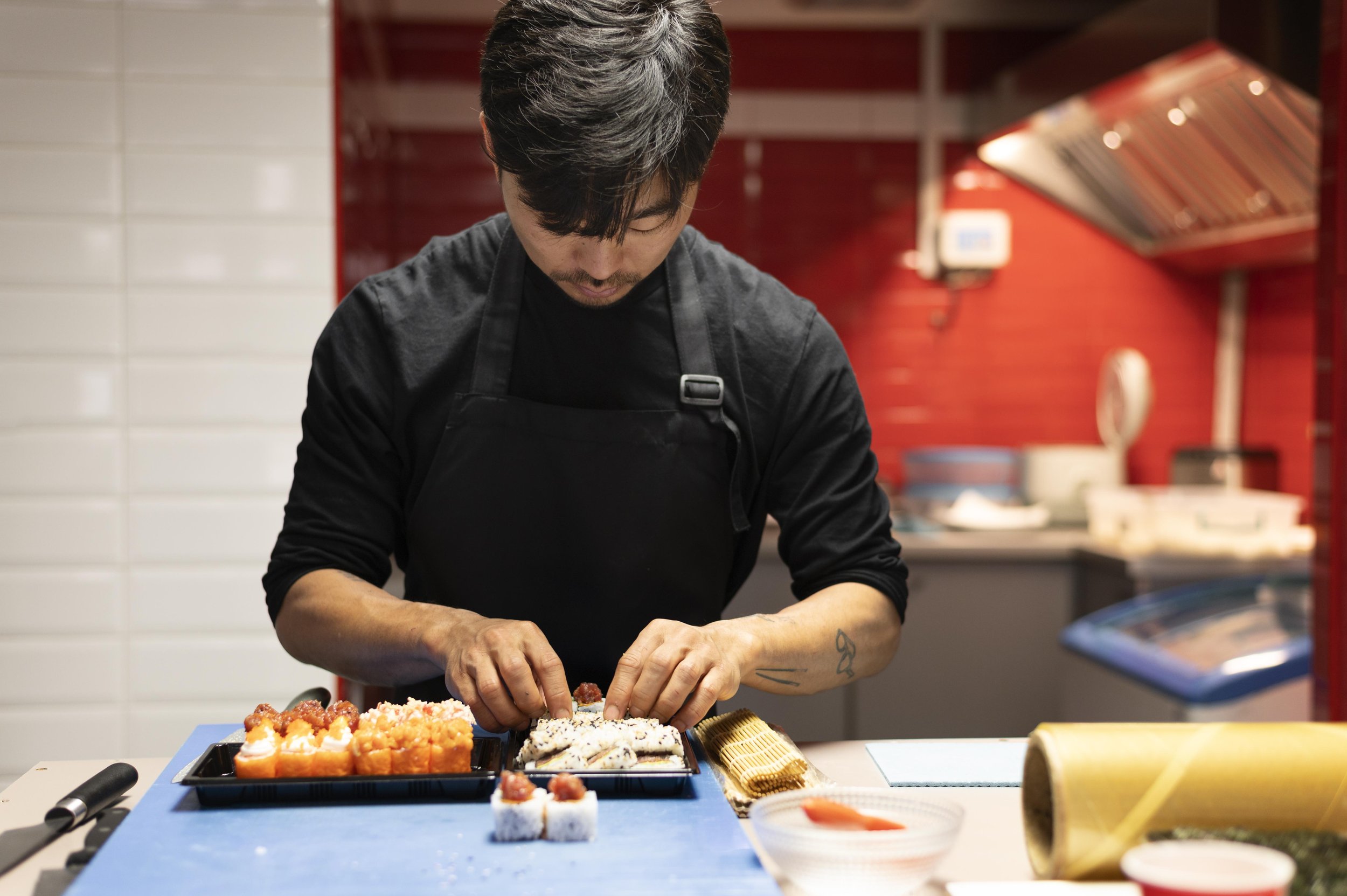 man-preparing-sushi-order-takeaway.jpg