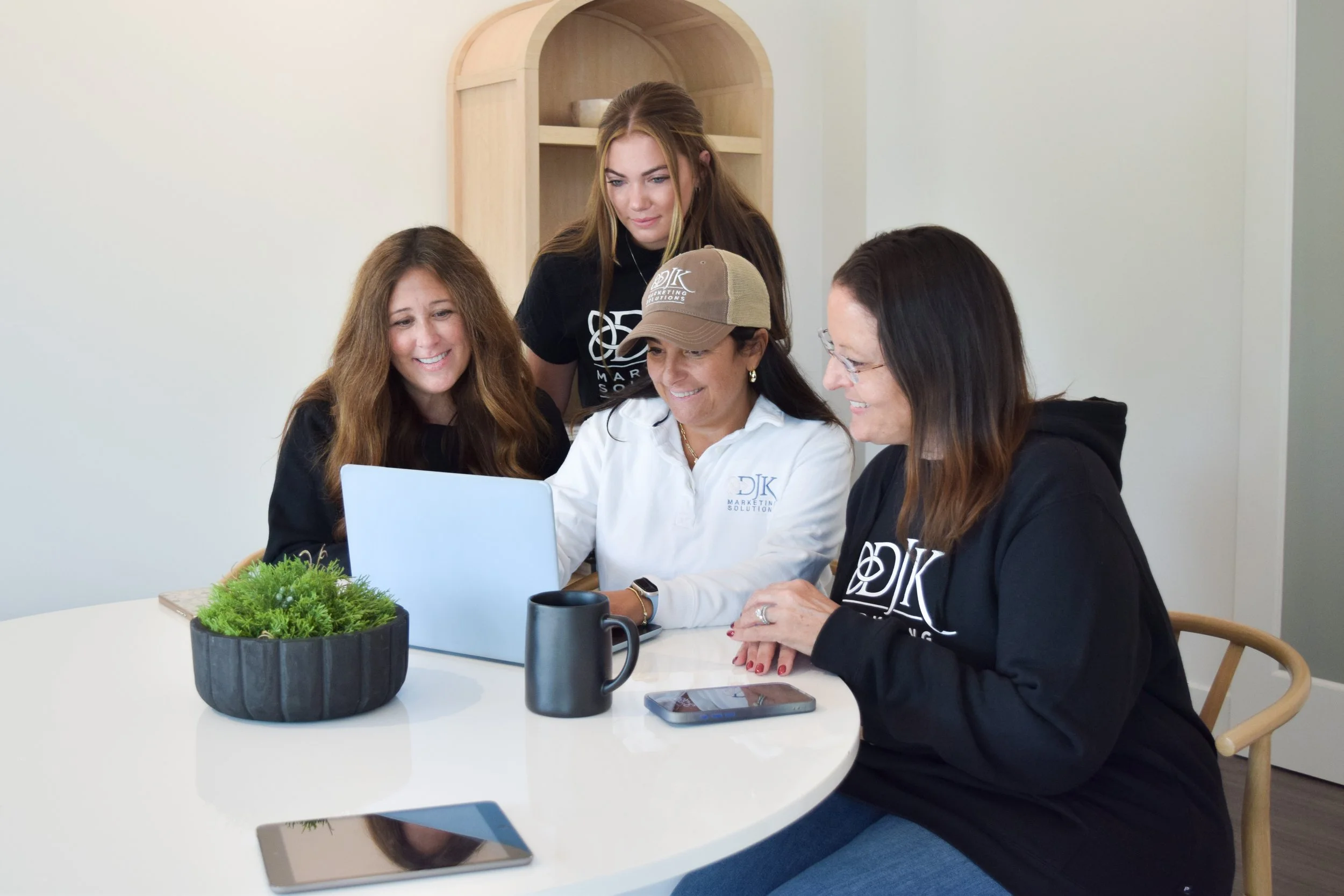 Digital marketing services showing consistent social media posts, email marketing campaigns, and branded graphics on laptop and mobile devices for small business branding