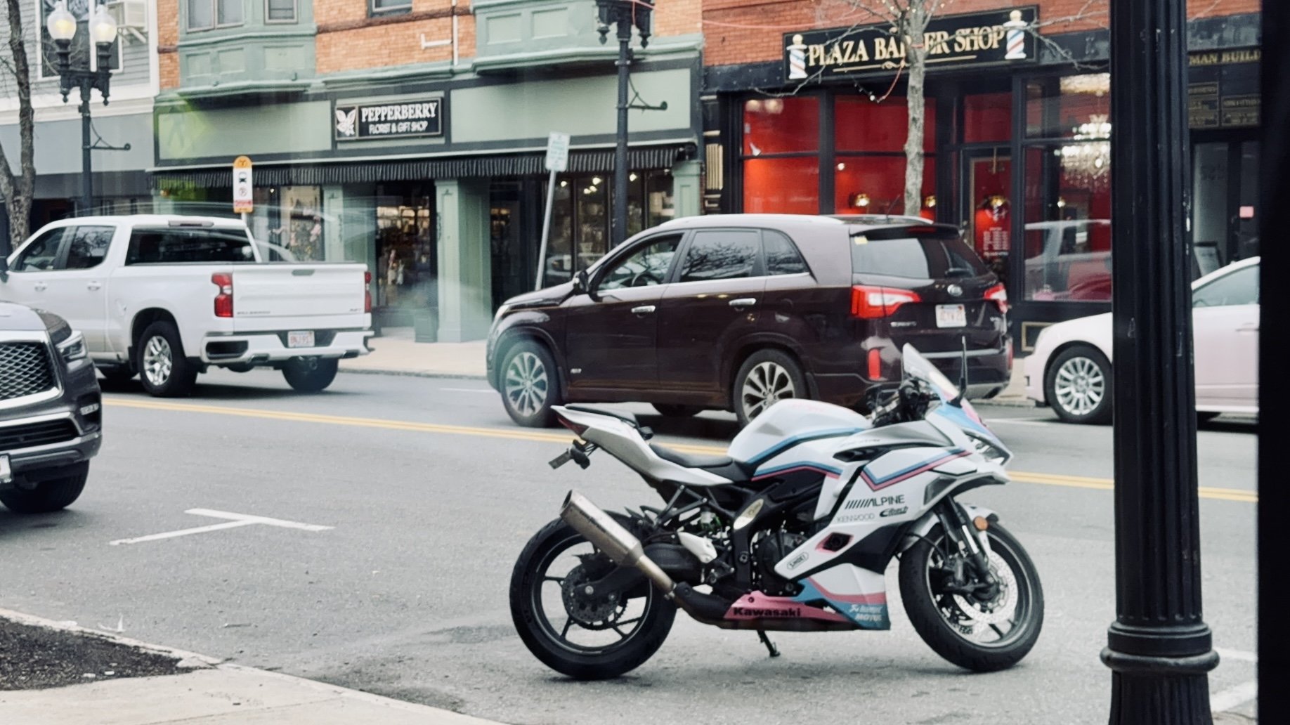 The ZX4, out in the world. White bodywork with pink and teal details.