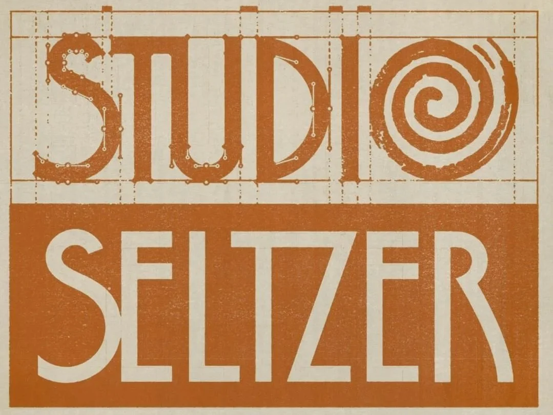 Sign with the text 'STUDIO SELTZER' in a vintage style, orange and white color scheme.