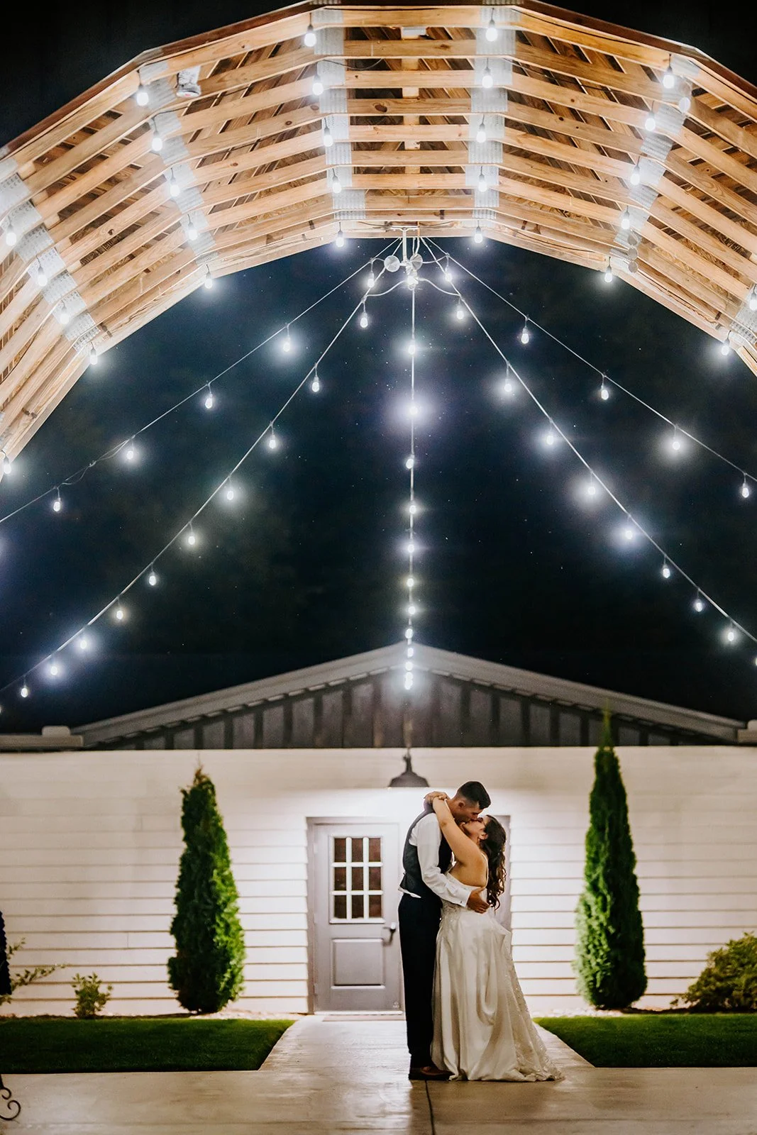 Newlyweds kiss outside wedding venue in Southwest Michigan