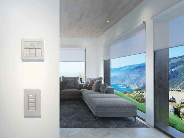 Coastal living room with glass walls (Private Residence): Lutron motorized roller shades and wall control panels