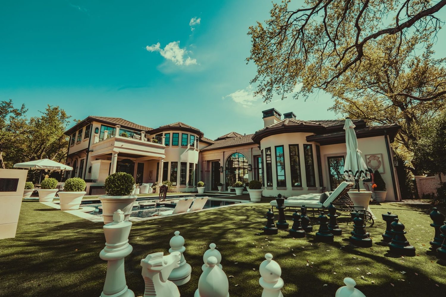 Exterior of a Barton Creek home with a pool and lawn