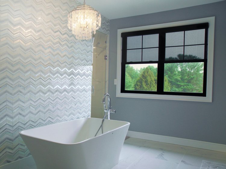 Bathroom with freestanding tub and chandelier (Private Residence, Saucon Valley, PA): Triathlon roller shades, a Ketra bulb and HomeWorks QSX