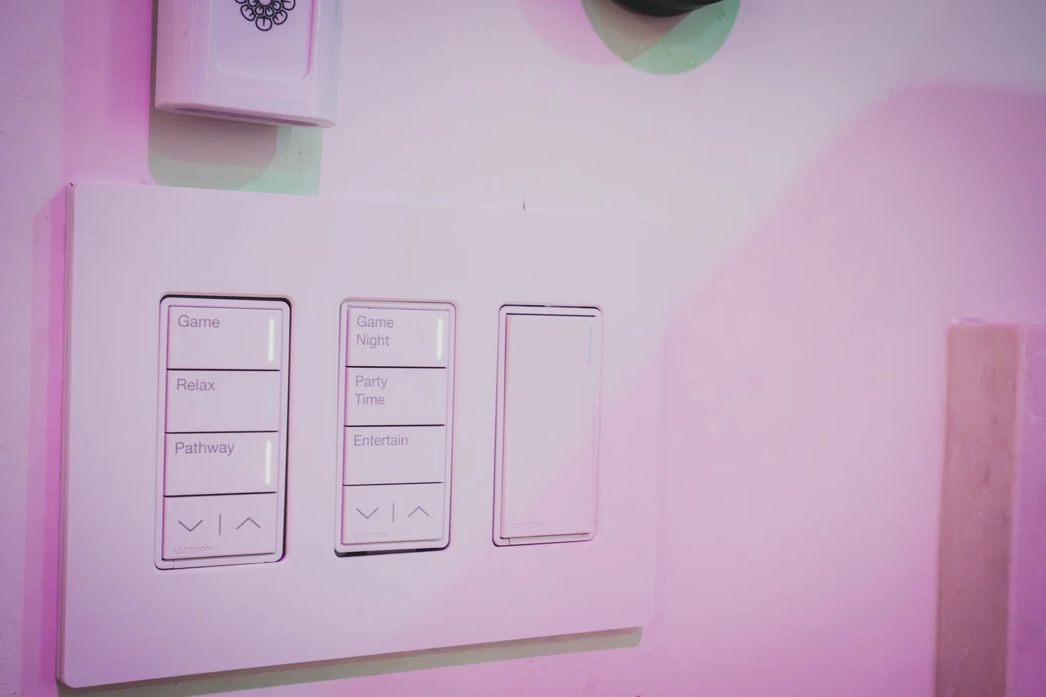 Lutron Sunnata scene keypads and dimmer lit in colored light