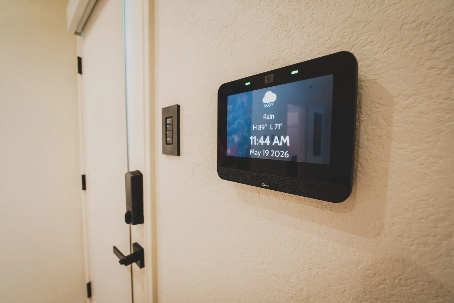 Wall-mounted touchscreen beside a door