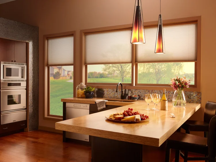 Kitchen with honeycomb shades (Private Residence, USA): Lutron motorized honeycomb shades and pendant lights