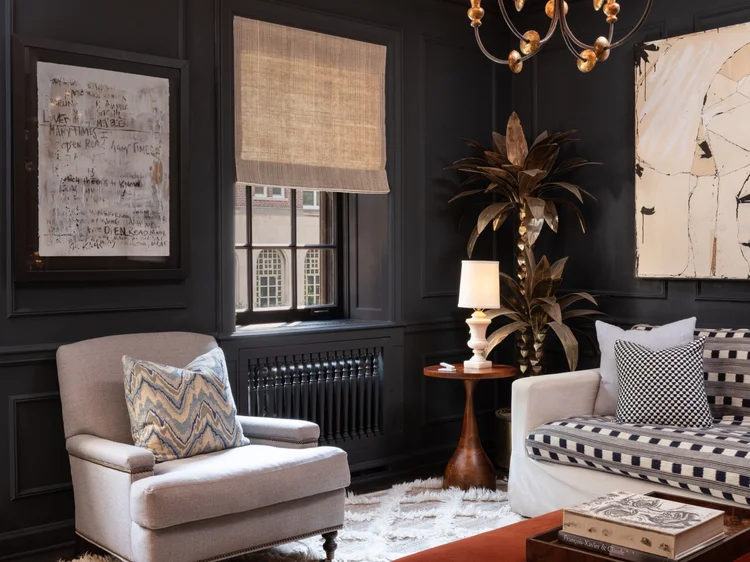 Living room with dark paneled walls (Private Residence, Chicago): Lutron lighting and a Roman shade