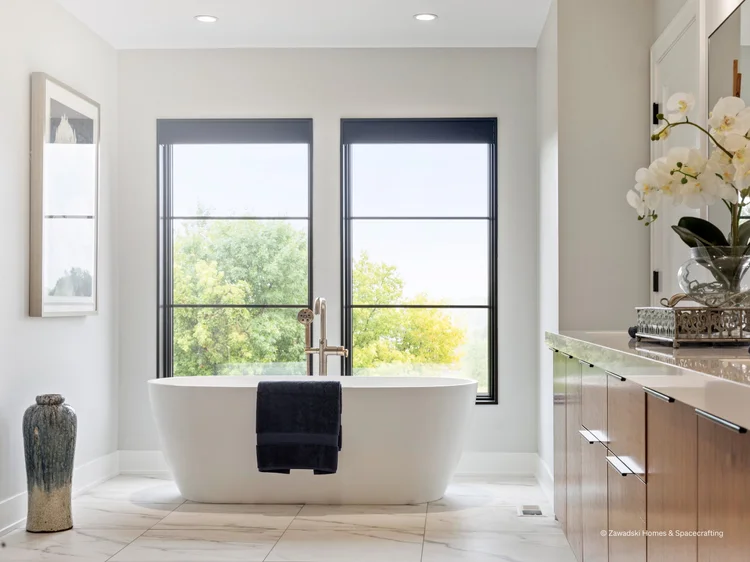 Bathroom with freestanding tub between windows (Whistling Valley Residence, Lake Elmo, MN): Ketra D2 downlights and HomeWorks QSX control