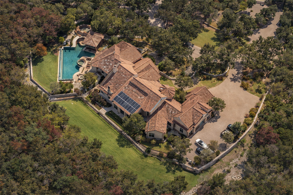 Aerial view of a sprawling 11,000-square-foot luxury estate in Austin, Texas, featuring a pool and cabana, undergoing an enterprise-grade smart home technology upgrade