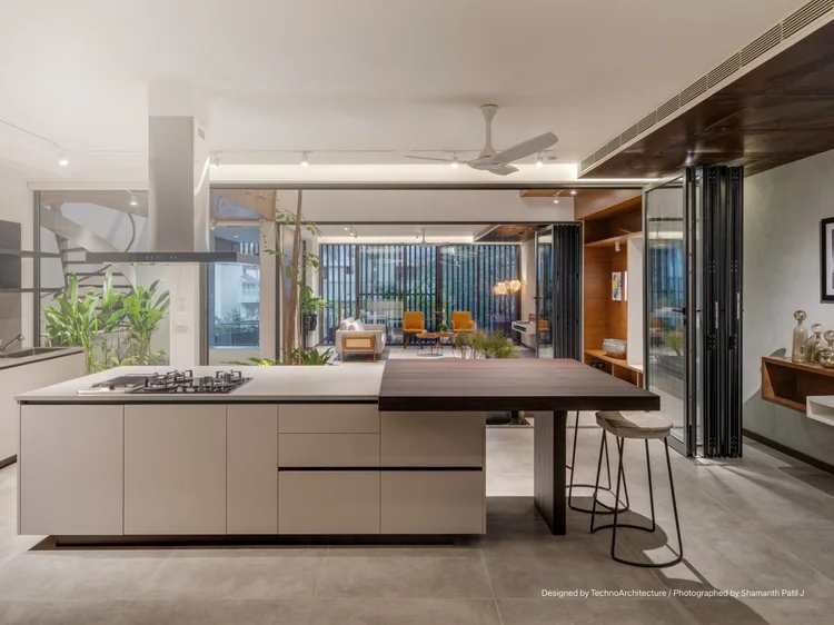 Open-plan kitchen and living space: Lutron lighting with track and recessed fixtures