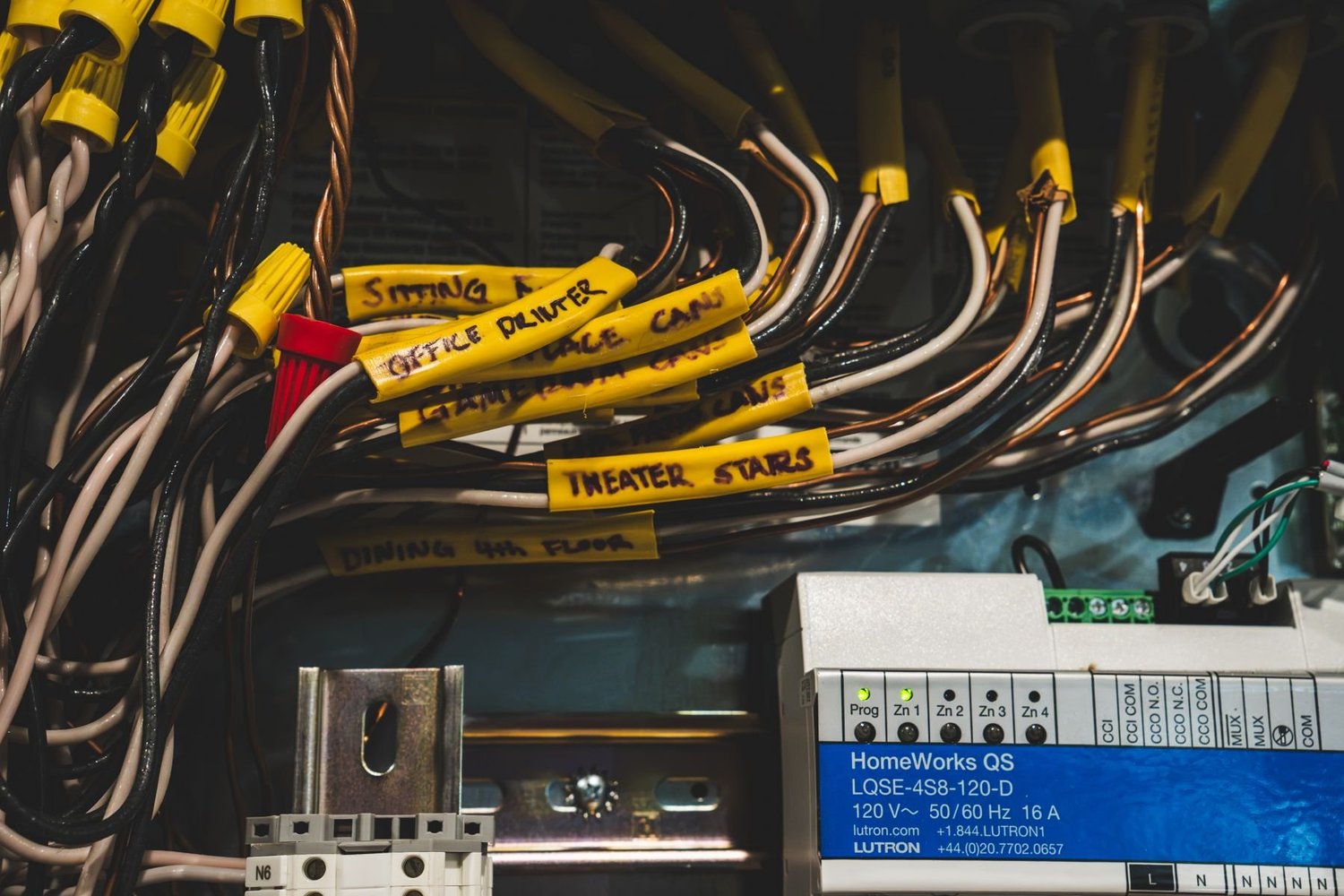 Close-up of labeled wiring above a HomeWorks QS module