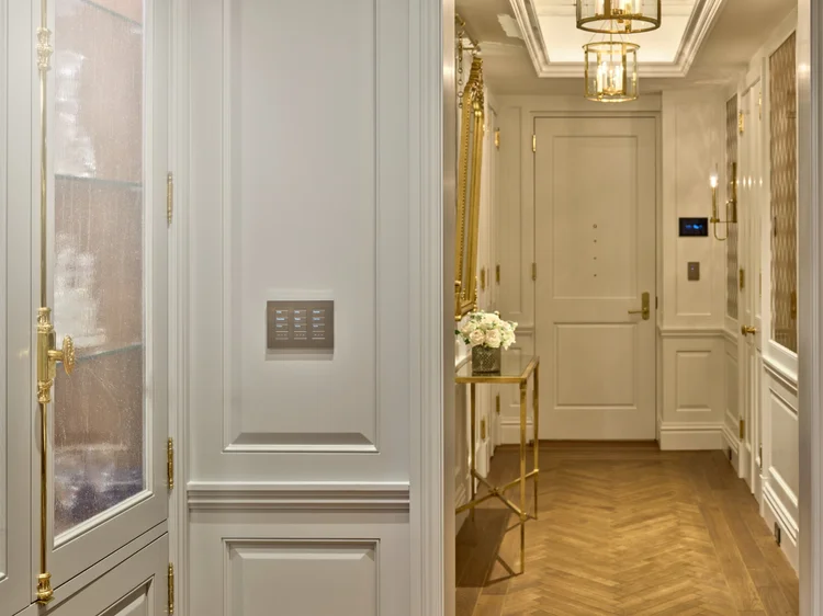 Foyer with wall keypad and pendant lanterns (Ritz Tower Residence): a Lutron wall keypad and layered lighting