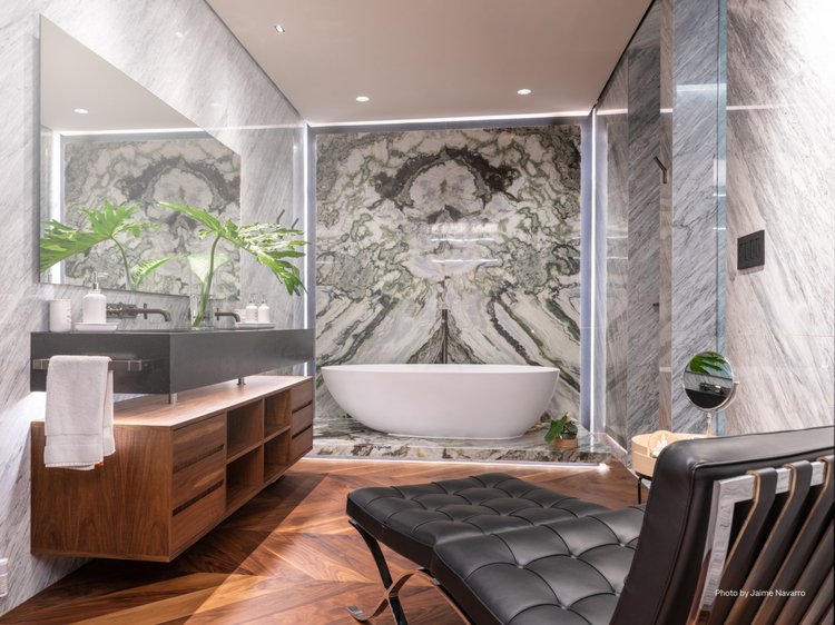 Bathroom with stone accent wall (Latin America Residence): Lumaris linear lighting and recessed downlights