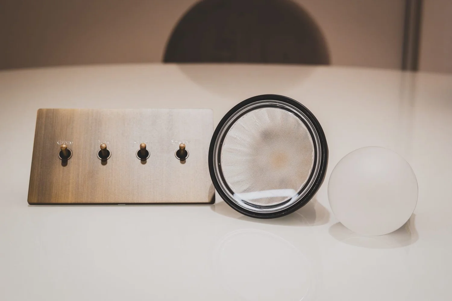 Ketra lamps beside a walnut toggle wall plate