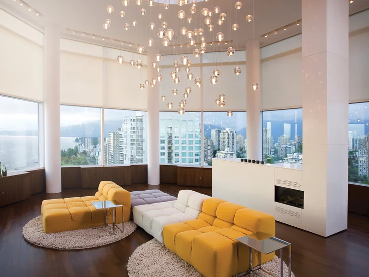 High-rise living room with city views (Los Angeles Experience Center, Los Angeles, CA): motorized shades, chandelier and HomeWorks QSX lighting