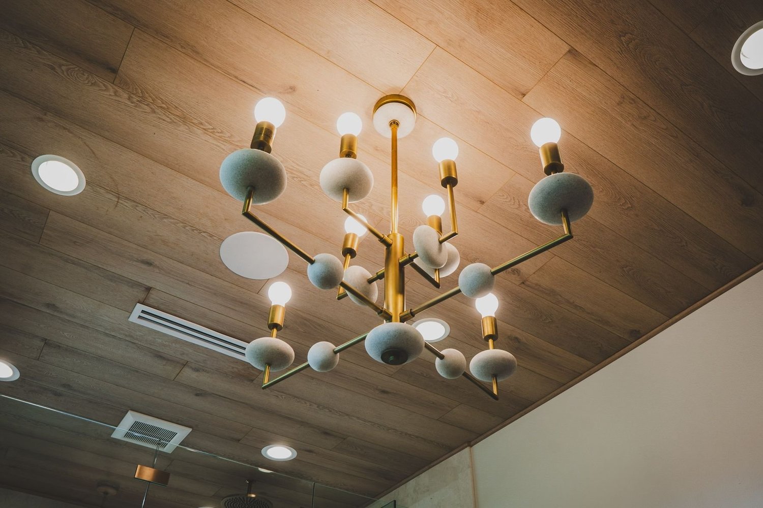 Chandelier with recessed lights and a ceiling speaker