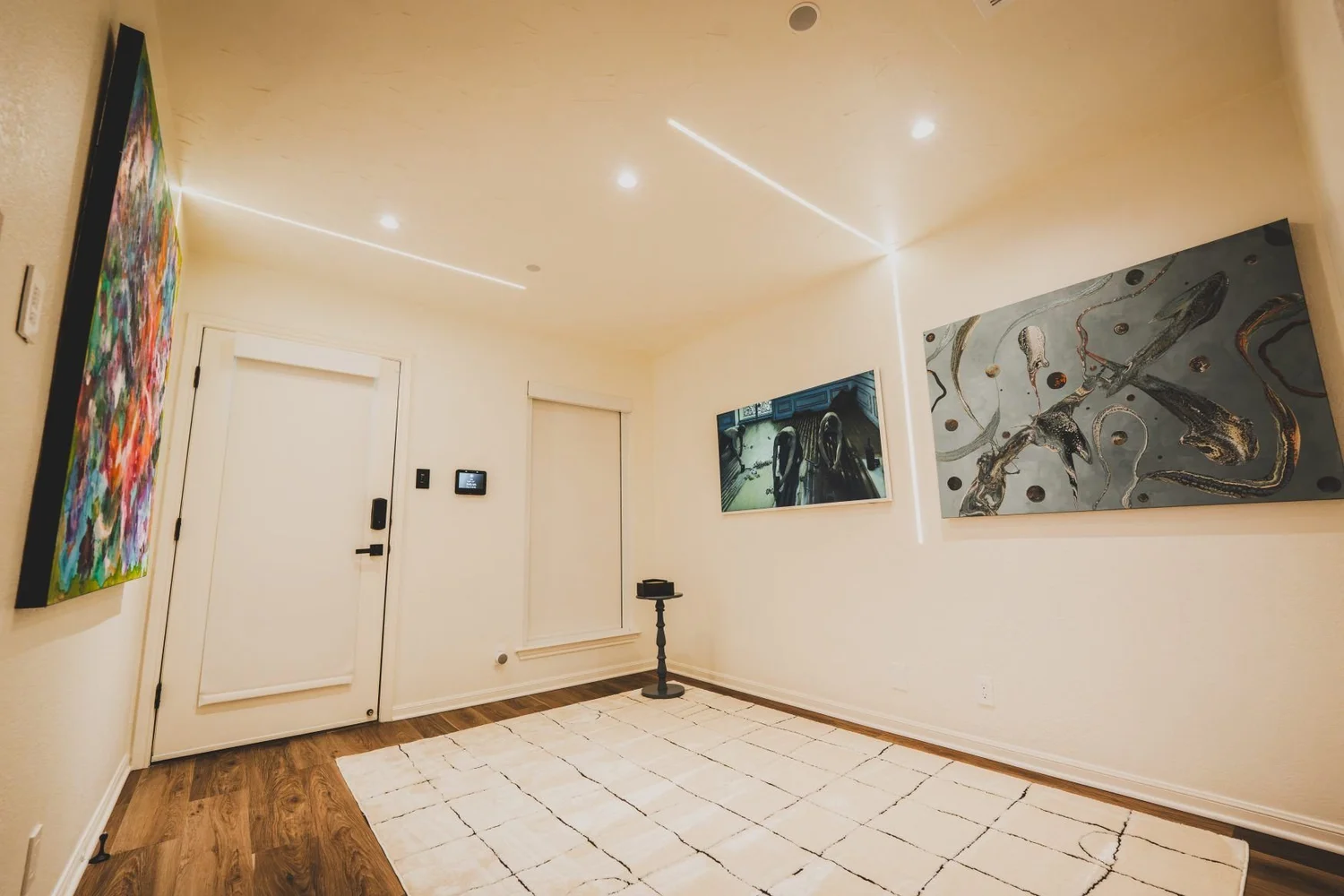 Showroom room with keypads and wall touchscreens beside artwork