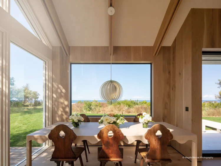 Dining room with floor-to-ceiling windows (Hamptons Barnhouse): Lutron motorized shades and a pendant fixture