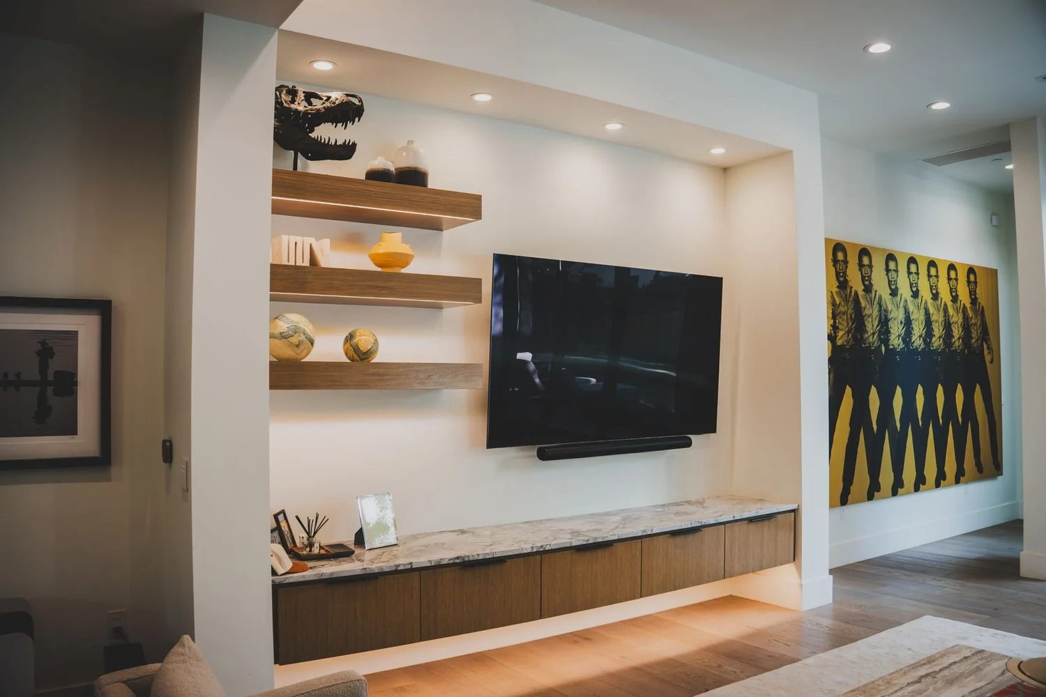 Living room media wall with shelves and television